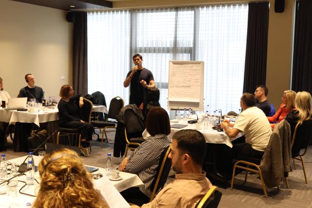 Participant presenting group work for all attendees of the workshop