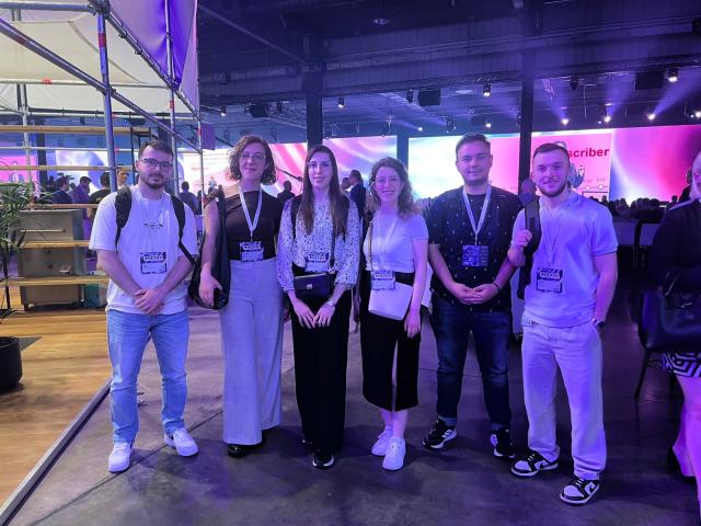 Group of students in front of screens at an event
