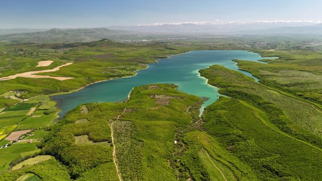 Radoniqi lake outside the city of Gjakova with mountain range in the background