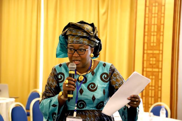 African woman speaking at a microphone