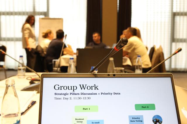 Illustration of group work with participants discussing in the background
