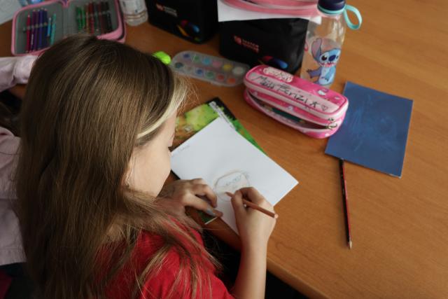 Children drawing in classrom as part of GRAN Fest workshop with kids
