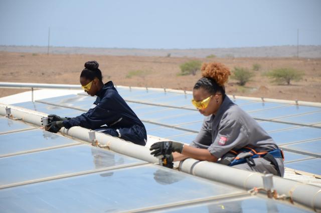 Deux jeunes filles capverdiennes s'occupant de la maintenance de panneaux solaires