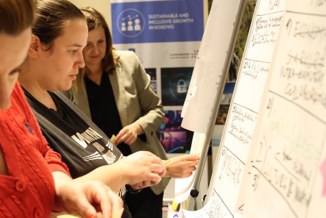 Participant sticking notes on standing board
