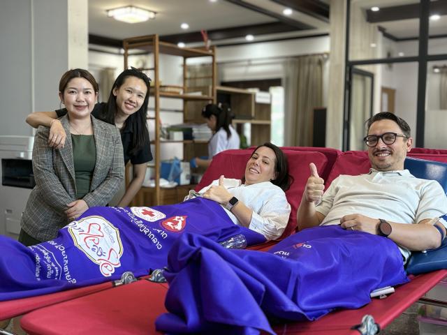 Two LuxDev staff donating blood