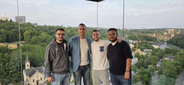 Group of students and their professor posing for a photo