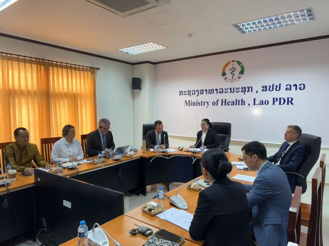Photo at the meeting room with MoH sign