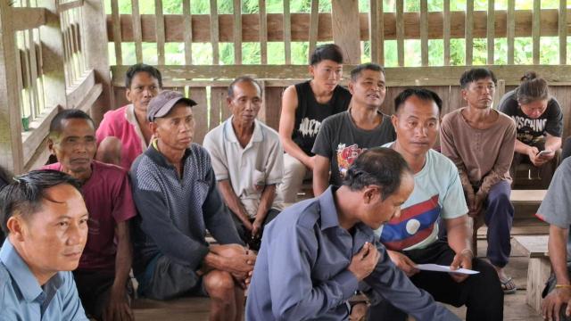 Villagers at the meeting with Lao flag T-shirt