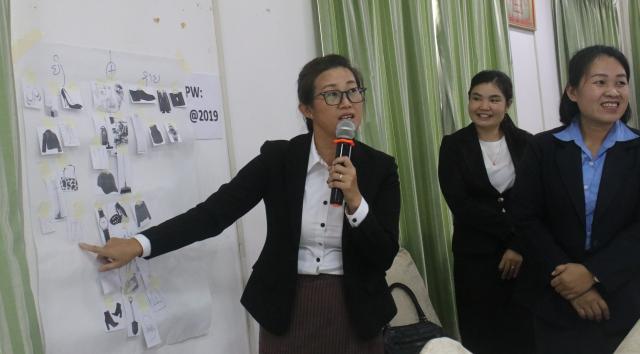 Work group, women presenting a poster
