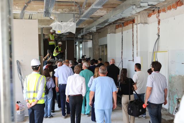 Group of people visiting works at clinic ward