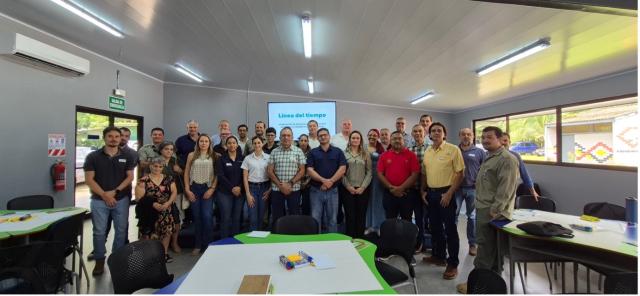 Group of people posing in a work room